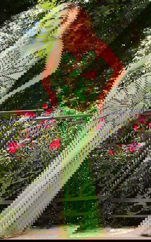 Model wearing Jovani 40129 elegant green dress with intricate bead details, front view.