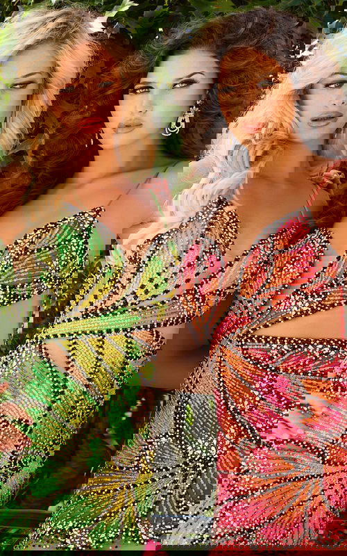 Two models wearing Jovani 40130 dresses with detailed embellishments and plunging necklines.