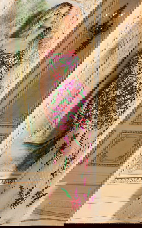 Model in Jovani 40149, featuring a front view of the multi-colored gown with intricate floral patterns.