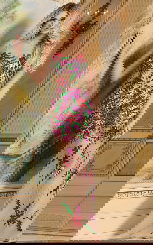 Model wearing Jovani 40149, a multi-colored floor-length gown with floral embroidery from the front.