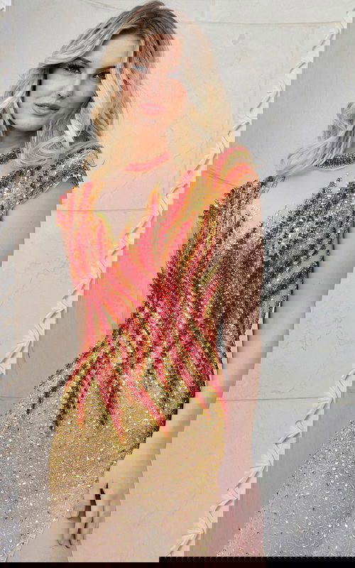 Close-up of model in Jovani 40157 nude dress with beaded flame details.