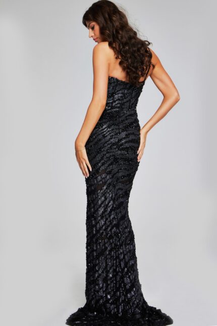 Model showcasing back details of Jovani 40182 black gown with embellishments.