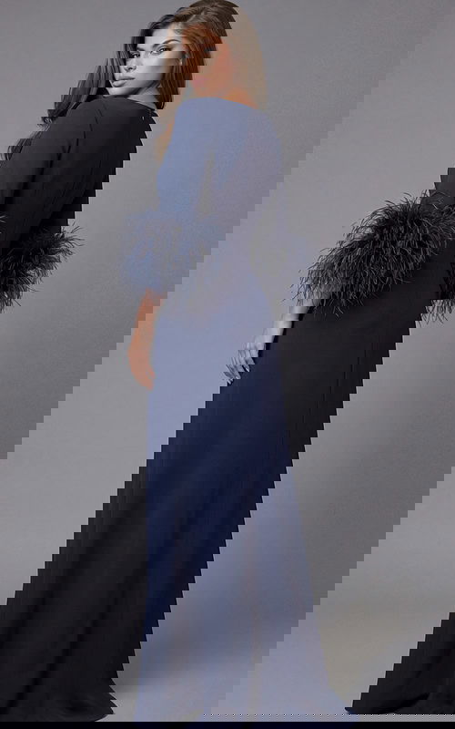 Long navy gown with minimalist neckline and dramatic feather sleeve cuffs