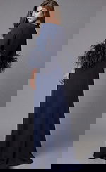 Long navy gown with minimalist neckline and dramatic feather sleeve cuffs