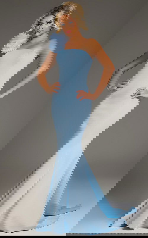 Model wearing Jovani 40201 blue mermaid dress with floral shoulder embellishment, front view.