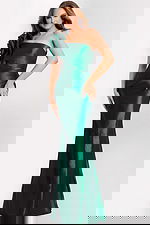 Woman wearing hunter green one-shoulder gown with floral detail