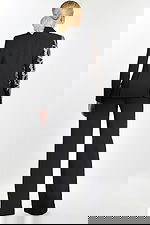 Back view of black formal pantsuit with one sequin-embellished sleeve.