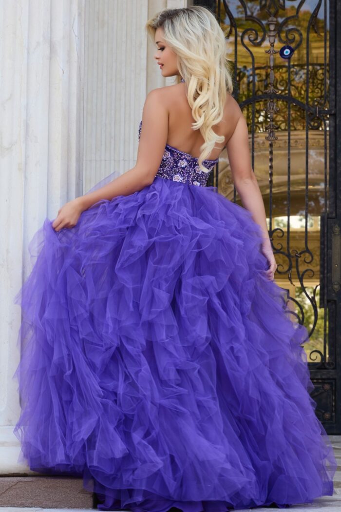Back view of model wearing Jovani 40218 lilac dress with open back design.