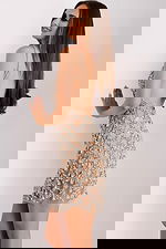 Back view of sleeveless nude dress featuring open back and silver beading