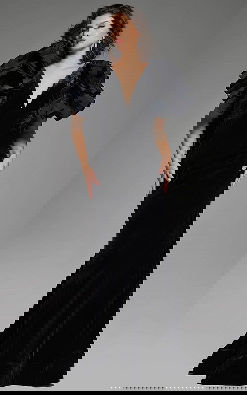 Elegant velvet gown with dramatic ruffled shoulders and deep V-neckline