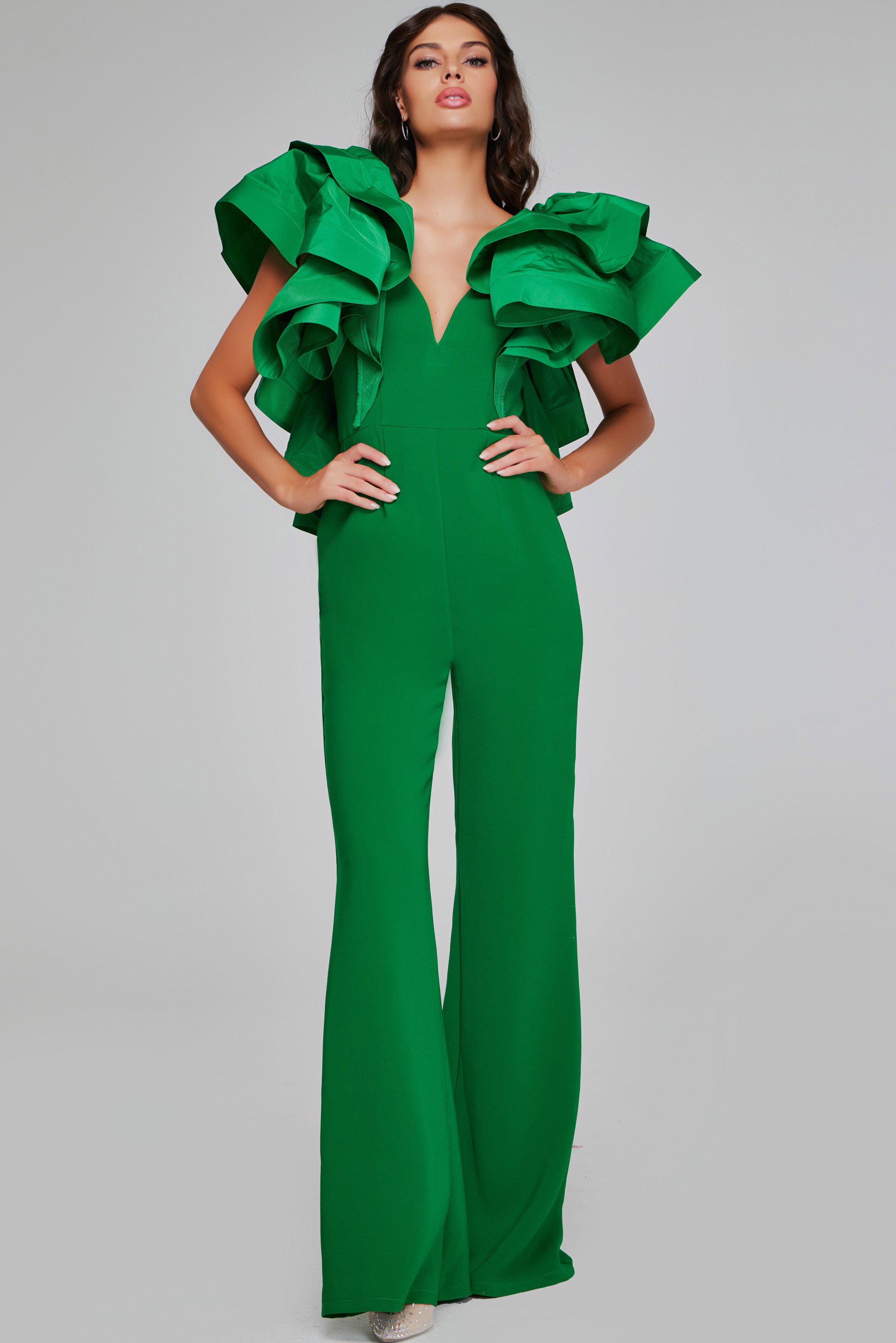 40291-EMERALD-201.jpg Model wearing Jovani 40291 emerald green jumpsuit featuring a V-neckline and dramatic ruffled sleeves.