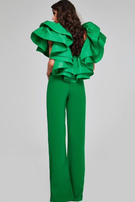 Back view of model wearing Jovani 40291 emerald green jumpsuit showing the ruffled sleeve detail.