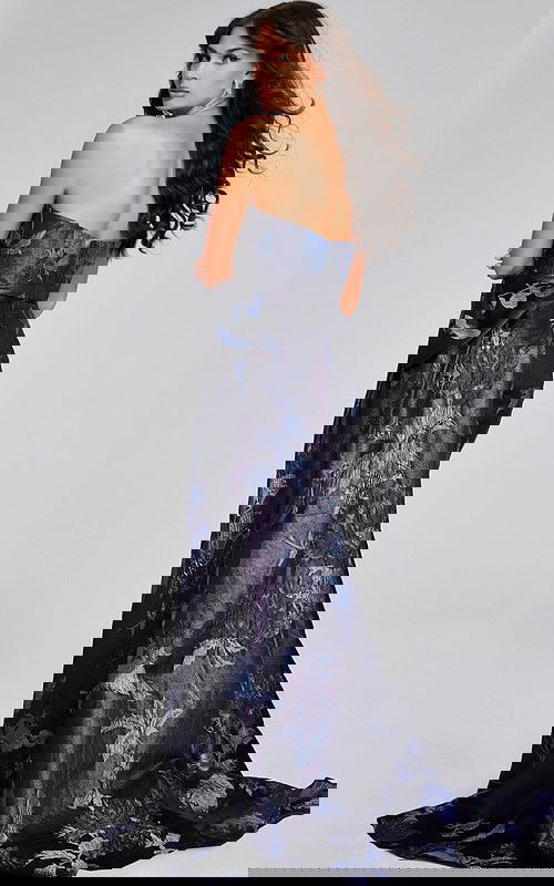 Model wearing Jovani 40308 elegant print gown with bow detail, back view.