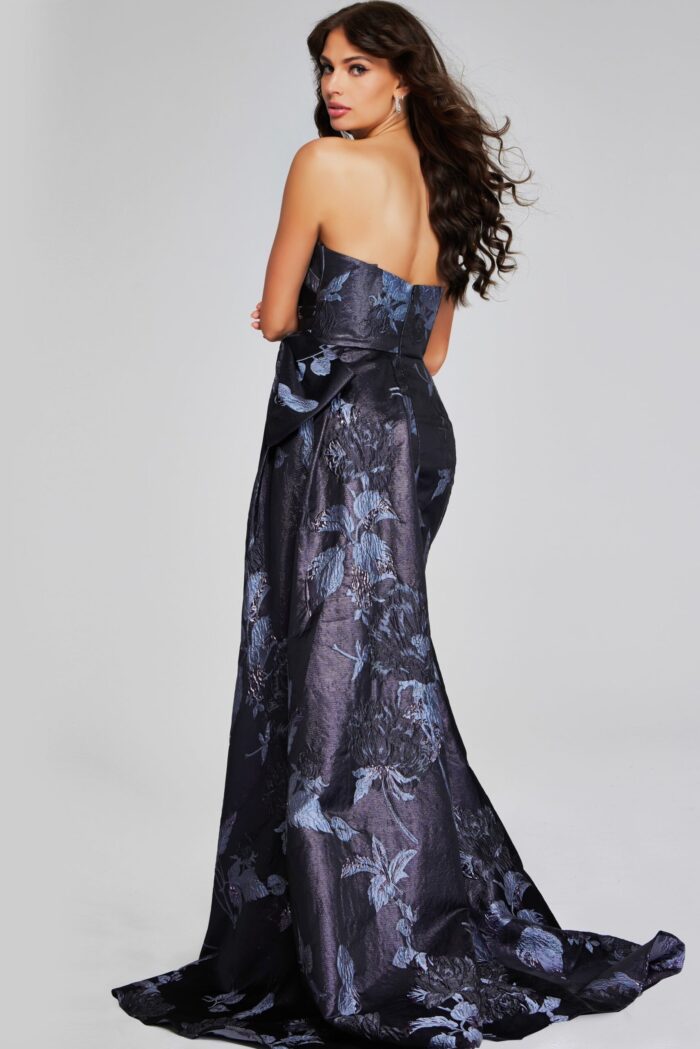 Model wearing Jovani 40308 elegant print gown with bow detail, back view.