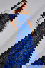 Model wearing Jovani 40315, a royal blue off-the-shoulder gown with puff sleeves.