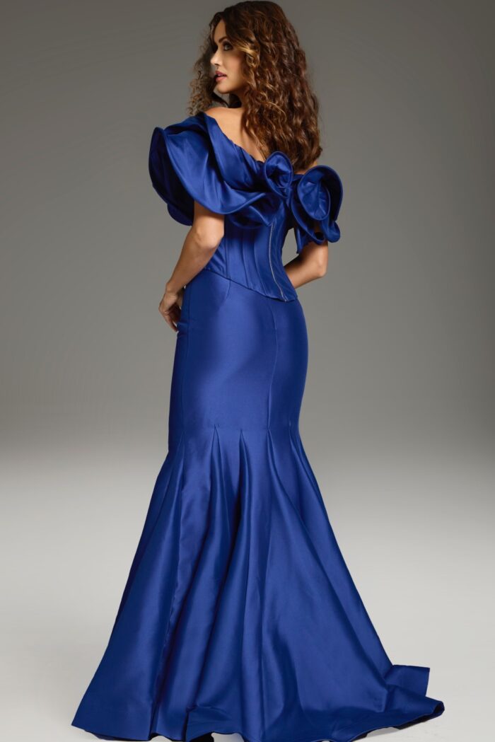 Model wearing Jovani 40324 purple mermaid gown with ruffle details, back view