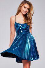 Model wearing Jovani 40350 blue short dress, front view with mosaic bodice and pleated skirt.