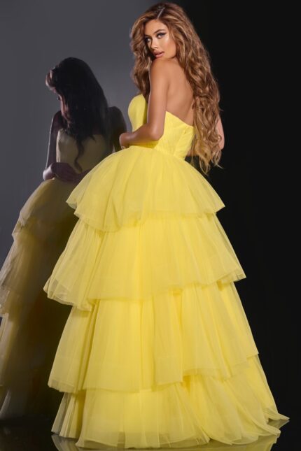 Model showing the back view of Jovani 40394 yellow ball gown.