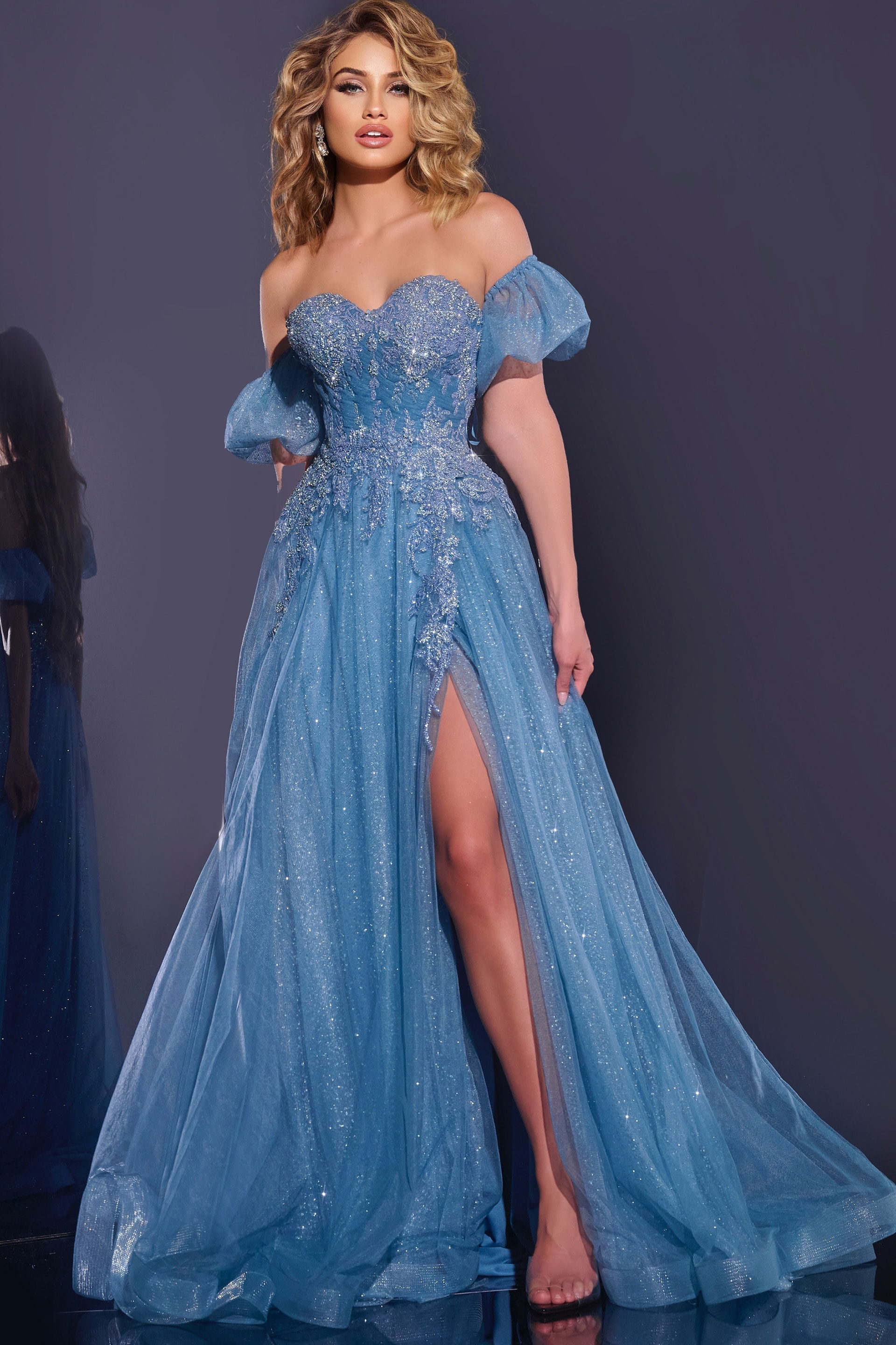 40474-2 Model wearing Jovani 40474 blue gown with sweetheart neckline and puff sleeves.