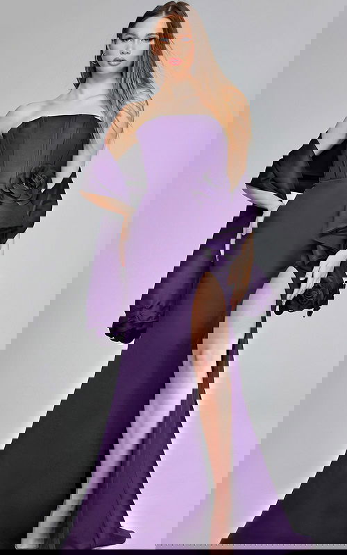 Model wearing Jovani 40592 purple gown with floral accent and high slit, front view