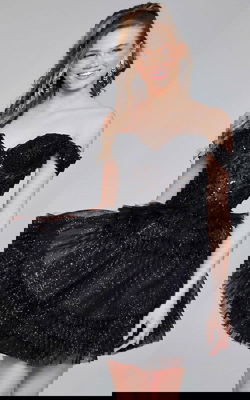 Model wearing Jovani 40612 black off-the-shoulder mini dress with sweetheart neckline and ruffled skirt.