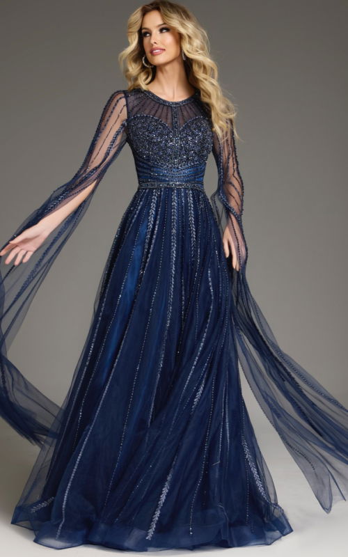 Model wearing Jovani 40629 navy gown with beadwork and long sheer sleeves.