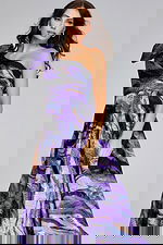 model wearing Jovani 40695 purple gown, showing front view with dramatic bow accent