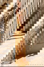 Fitted floor-length gown featuring intricate sequin detailing