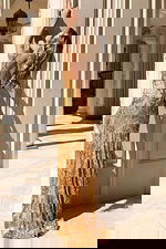 Fitted floor-length gown featuring intricate sequin detailing