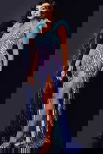 Model wearing Jovani 40761 gown with V-neckline and high slit in blue.