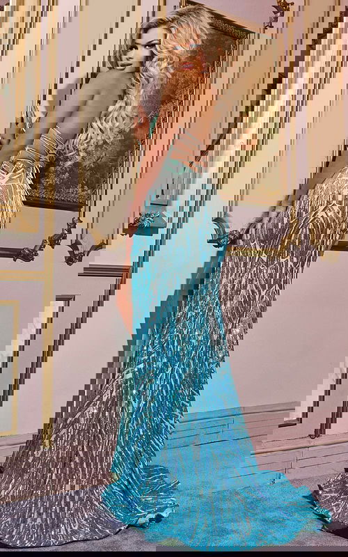 Model wearing Jovani 40763 dress showcasing open back and intricate beadwork, back view.