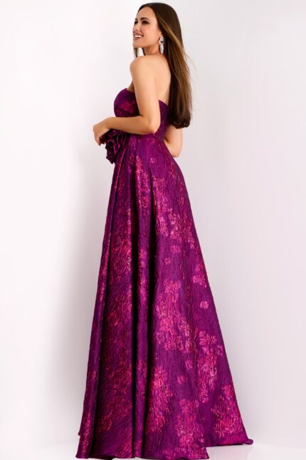 Back view of long formal fuchsia jacquard gown with rosette accent