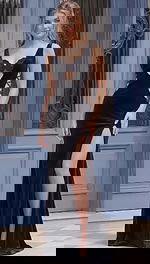 Front view of a fitted evening gown with a deep V neckline, side cutouts, and a high leg slit