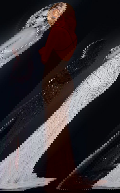 Model showing the back of Jovani 40820 silver gown with criss-cross detail.