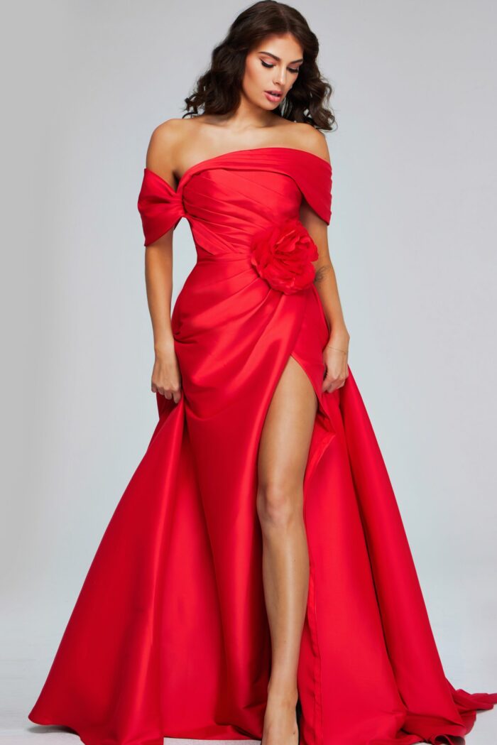 Model wearing Jovani 40832 red gown featuring an off-shoulder neckline and high slit