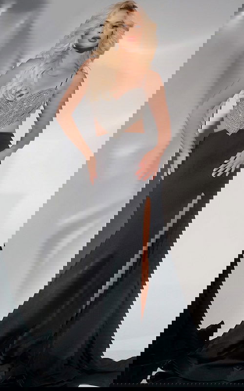 Model wearing Jovani 40884 black gown with beaded sweetheart bodice and high slit