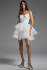 Model wearing Jovani 41054 white dress with strapless sweetheart neckline and layered skirt, front view.