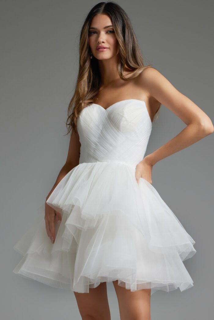 Model wearing Jovani 41054 white dress with strapless sweetheart neckline and layered skirt, front view close-up.