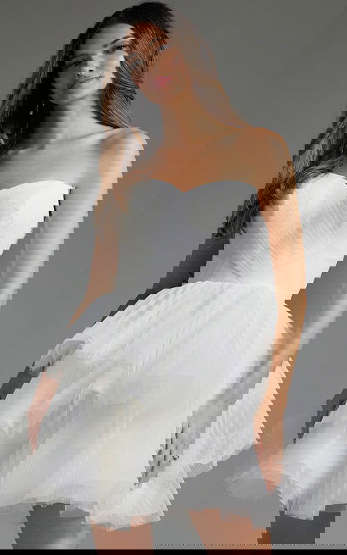 Model wearing Jovani 41054 white dress with strapless sweetheart neckline and layered skirt, front view.