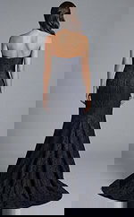 Back view of strapless textured gown with smooth bodice and flared hem