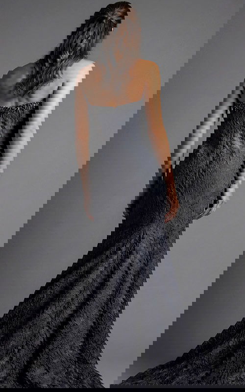 Back view of strapless evening gown with textured fabric and floor length flared hem