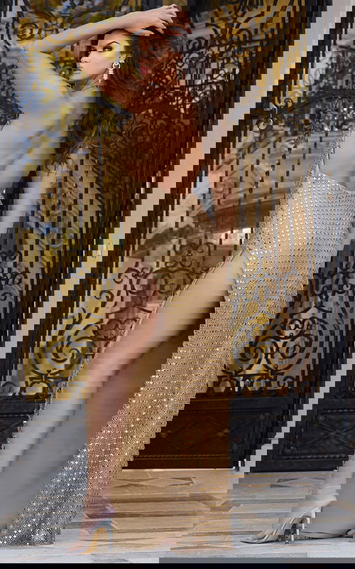 Back view of Jovani 42015 gold gown with high slit.