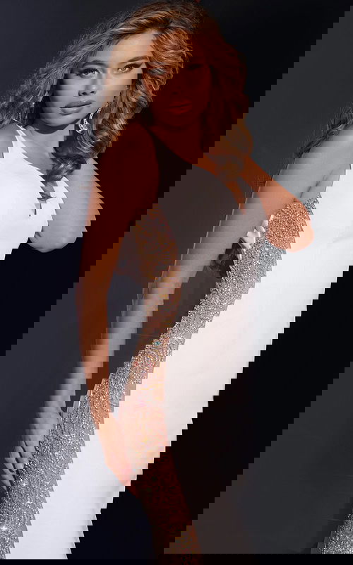 Model showcasing the back of Jovani 42025 gown with deep V-back and flowing silhouette.