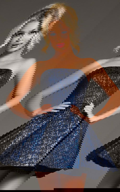 Model wearing Jovani 42135, front view, navy strapless short flared dress with animal print design.