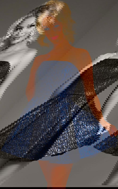 Model showcasing Jovani 42135, front view, navy strapless short dress with a flared skirt and animal print.