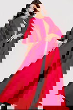 Dramatic floor-length cape with flared sleeves and open front, styled in bold satin fabric for a statement look.