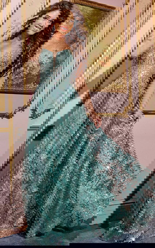 Model wearing Jovani 42199 green gown with sweetheart neckline and sequin embellishments