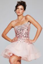 Model wearing Jovani 42282 pink short dress with one-shoulder design.