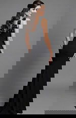 Back view of a fitted gown with floral appliqué detail and clean open back line