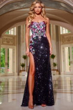 Model wearing Jovani 42303 black sequin gown with floral embroidery and high slit from the front.